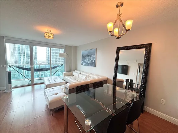 a view of a dining room with furniture wooden floor and chandelier