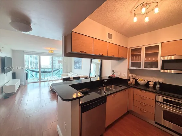 a kitchen with granite countertop a sink and stove