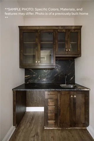 a kitchen with granite countertop a stove and a microwave