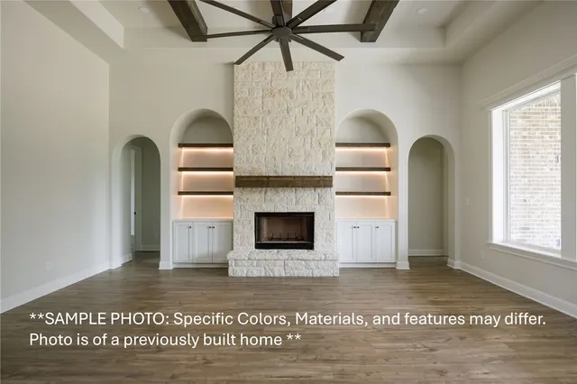 a view of a livingroom with a fireplace and window