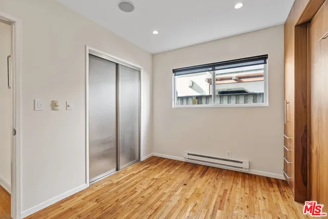 a bathroom with a granite countertop sink a mirror and a shower