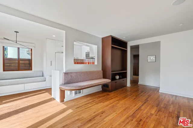a big room with wooden floor and closet