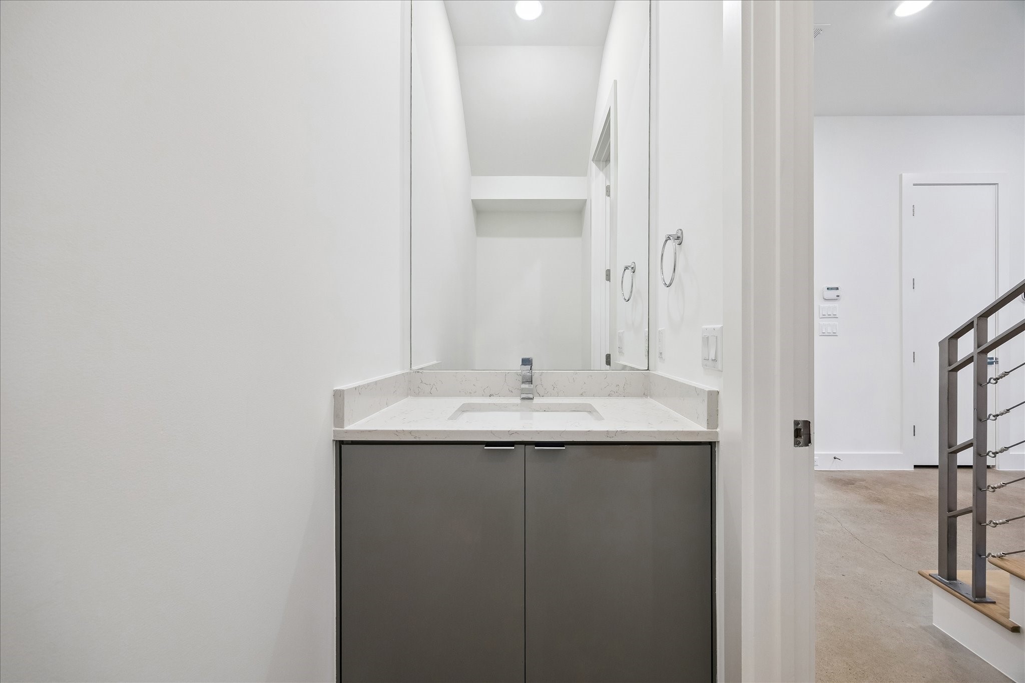 2147 Harold Street Houston, TX 77098 - Photo 13 of 28 Powder Room: Tucked away on the first level, featuring a sleek vanity with quartz countertop and clean, modern finishes—ideal for guest use.