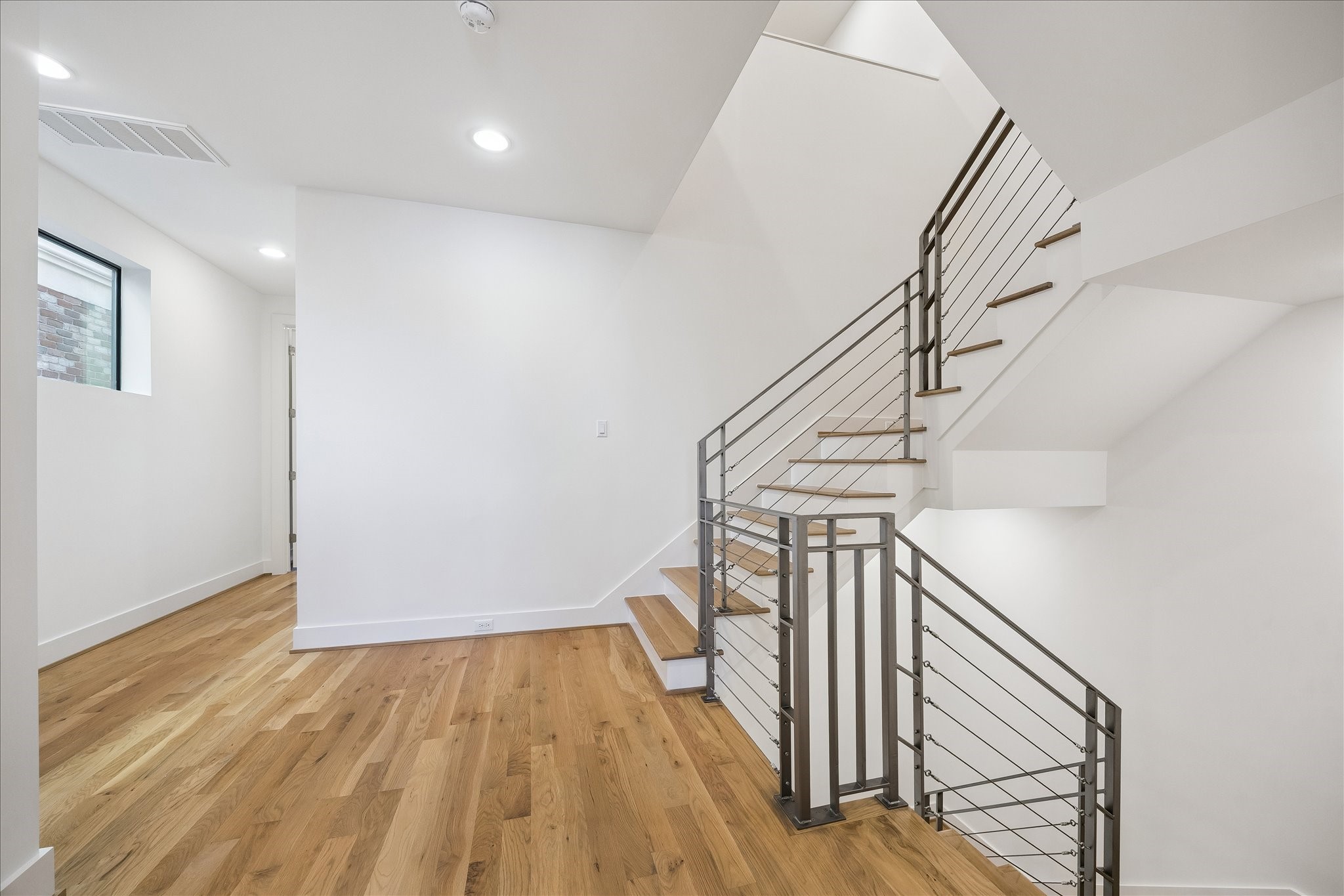2147 Harold Street Houston, TX 77098 - Photo 14 of 28 Staircase / Second Level Gallery: Modern open-riser staircase leads to a spacious landing, complemented by elevator shafts on each level for future installation.