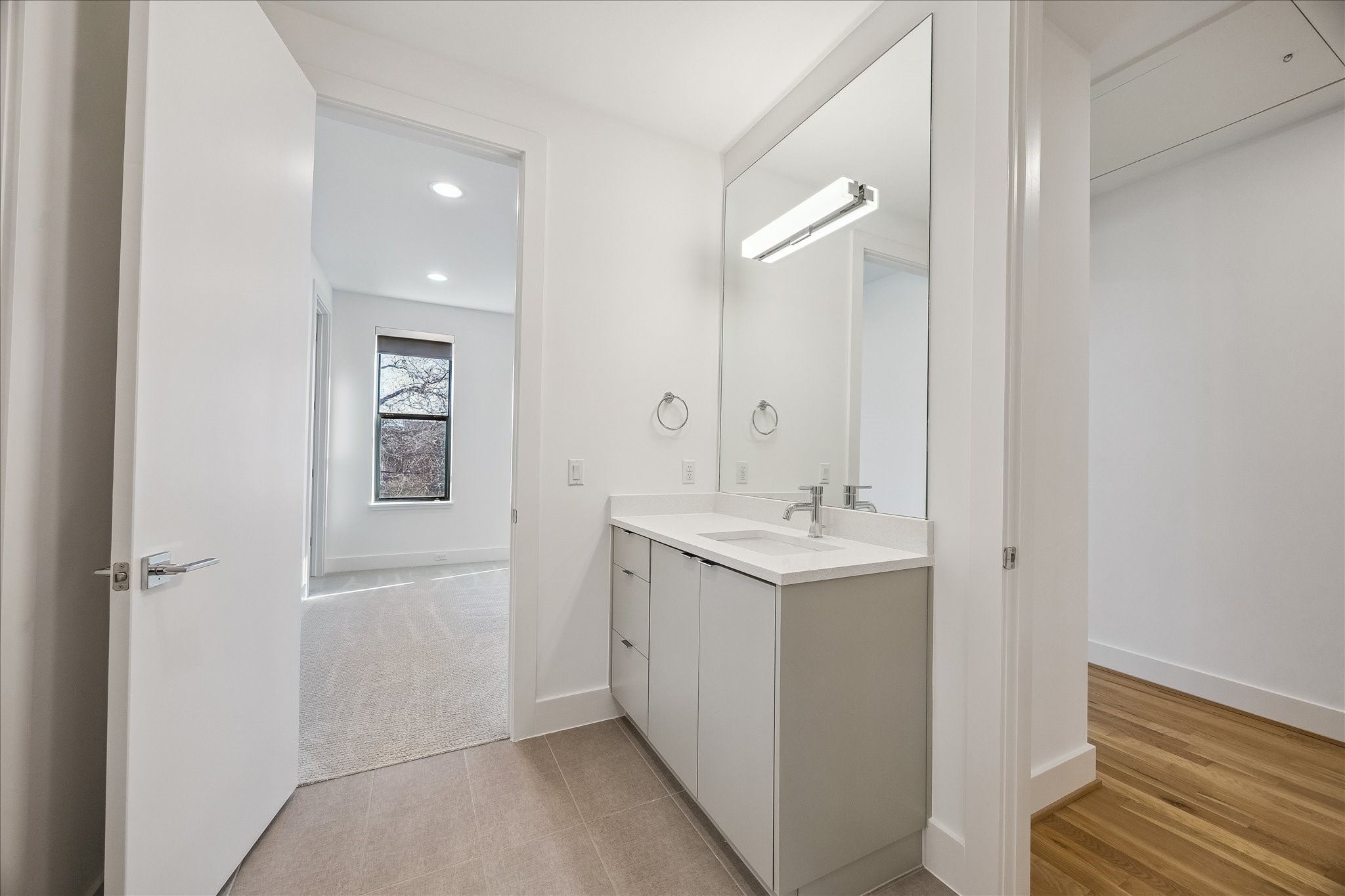 2147 Harold Street Houston, TX 77098 - Photo 26 of 28 Bathroom 3-Third Level- Serves Bedrooms 3 and 4 with convenient multi-access entry, featuring a modern vanity with quartz countertops and clean, contemporary finishes.