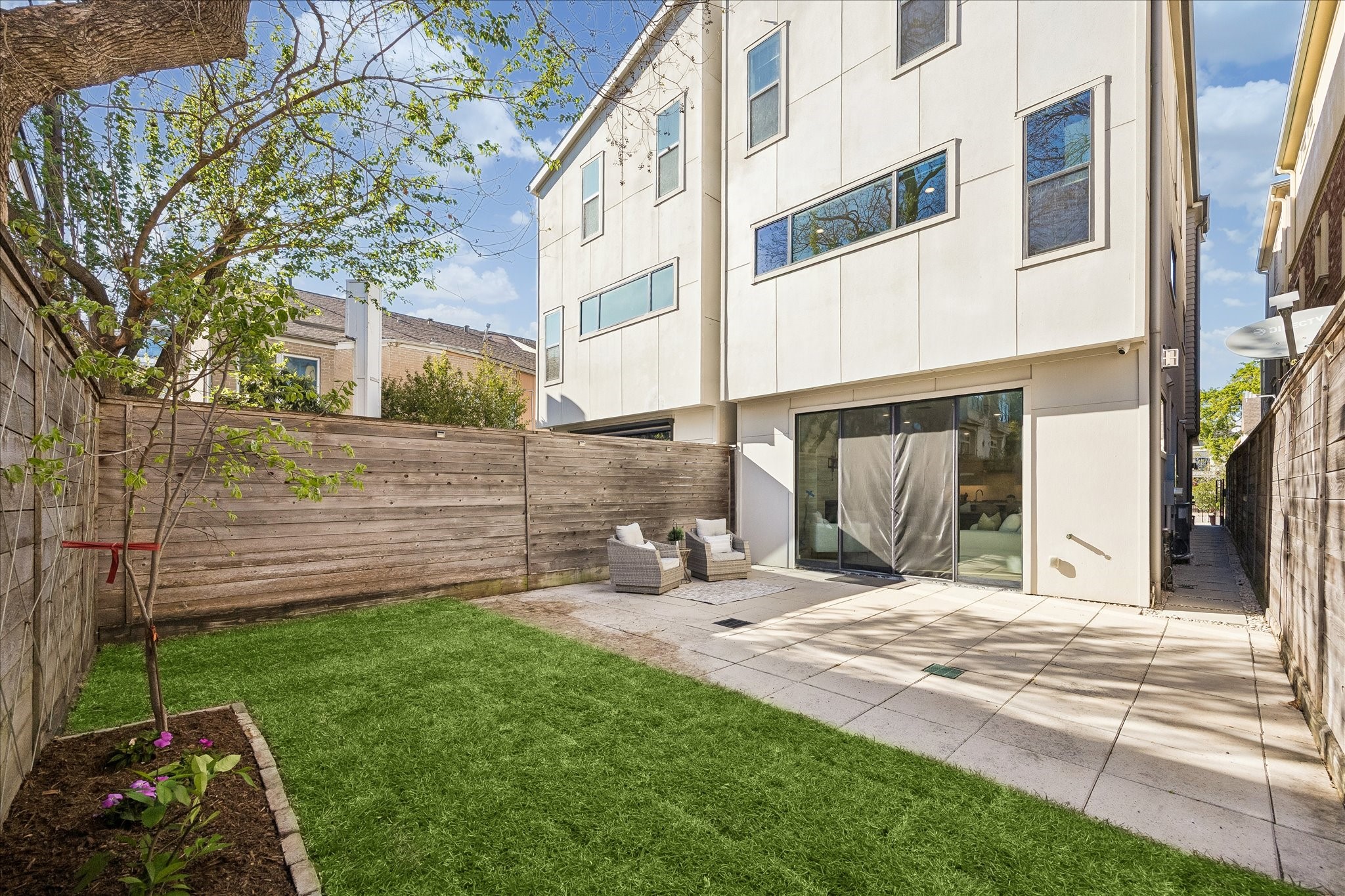 2147 Harold Street Houston, TX 77098 - Photo 28 of 28 Private Backyard: A well-designed outdoor space with a spacious patio and green lawn, enhanced by a screened enclosure—ideal for pets, relaxing, and entertaining.