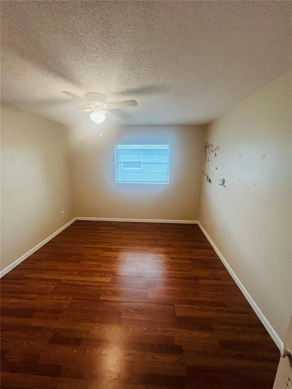 715 Michigan Court, Unit 3 St. Cloud, FL 34769 - Photo 12 of 15 a view of wooden floor and windows in a room