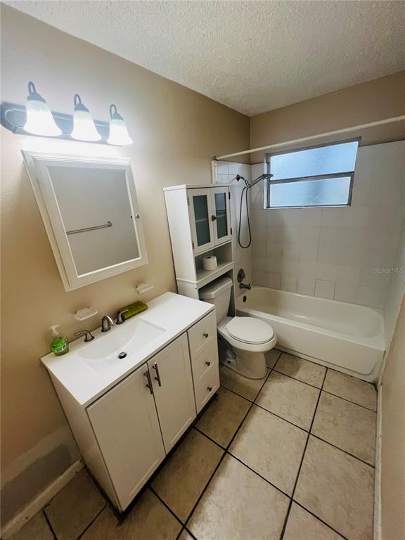 715 Michigan Court, Unit 3 St. Cloud, FL 34769 - Photo 13 of 15 a bathroom with a sink toilet and shower