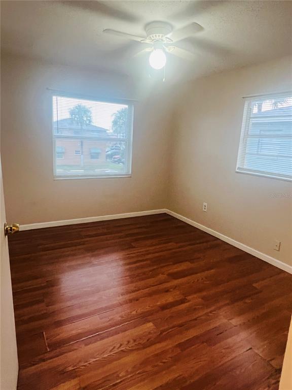 715 Michigan Court, Unit 3 St. Cloud, FL 34769 - Photo 14 of 15 a view of a room with wooden floor and window
