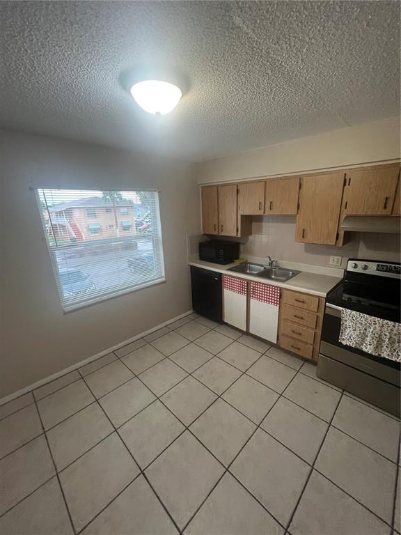 715 Michigan Court, Unit 3 St. Cloud, FL 34769 - Photo 7 of 15 a kitchen with stainless steel appliances a stove a sink and a refrigerator