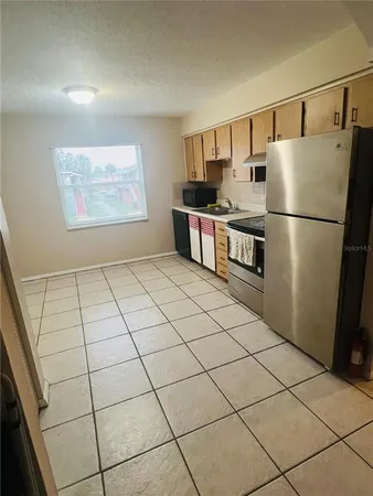 a kitchen with stainless steel appliances a refrigerator sink and cabinets
