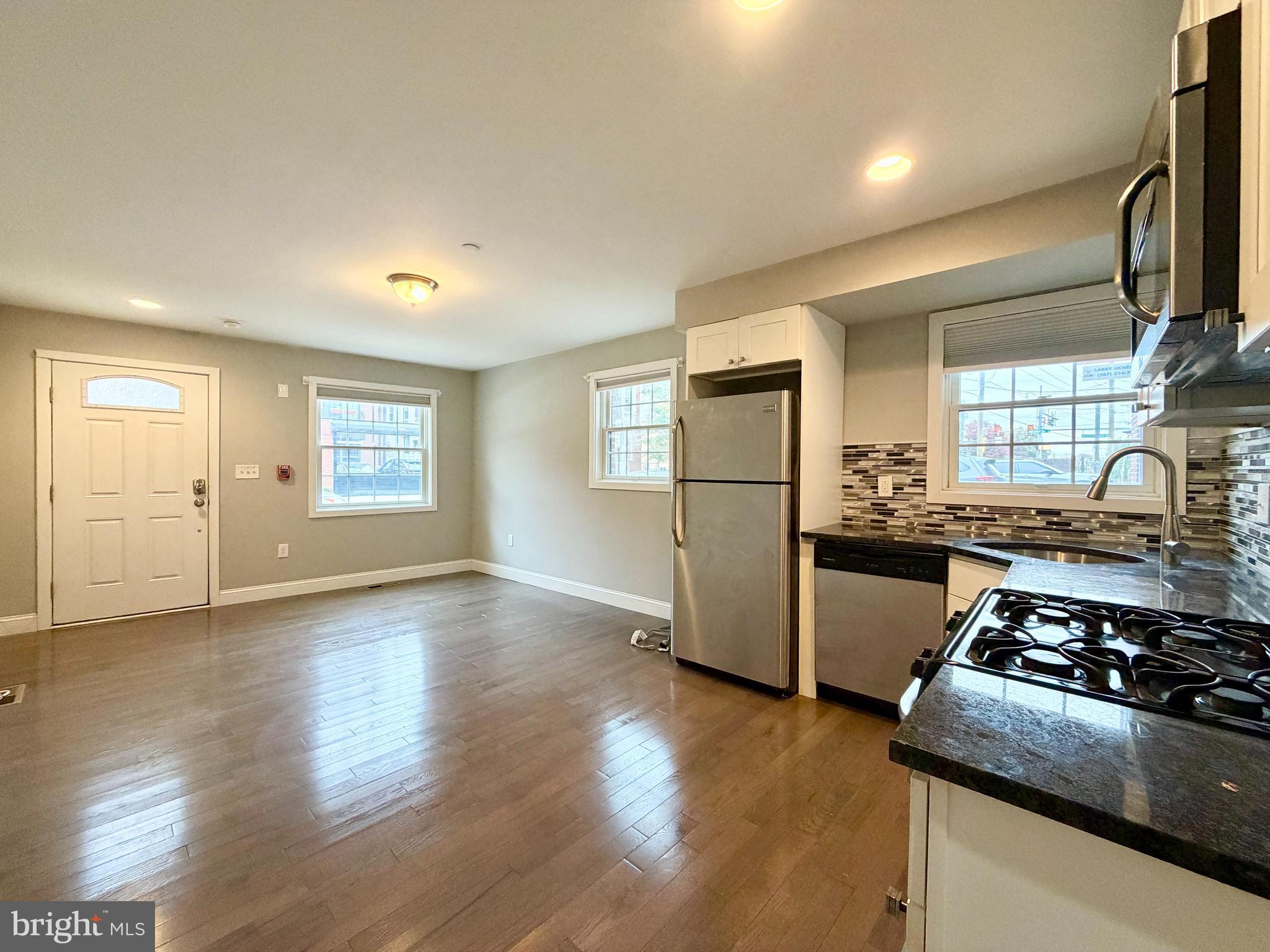 1014 East Moyamensing Avenue, Unit 1 Philadelphia, PA 19147 - Photo 10 of 11 a kitchen with granite countertop a stove and a refrigerator