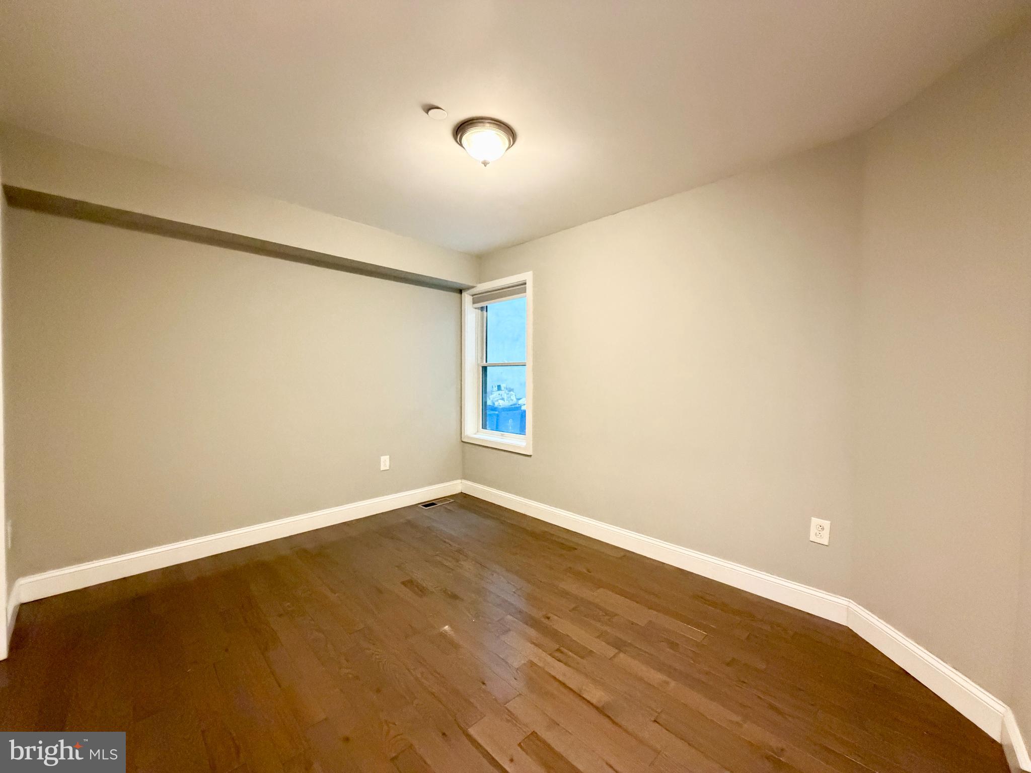 1014 East Moyamensing Avenue, Unit 1 Philadelphia, PA 19147 - Photo 2 of 11 a view of an empty room with wooden floor