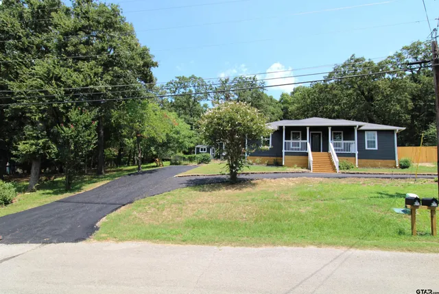 a view of a house with sitting area and garden