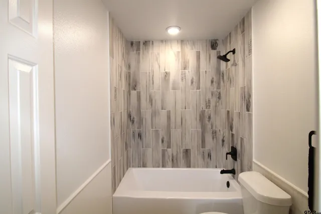 a bathroom with a bathtub a shower and a tub