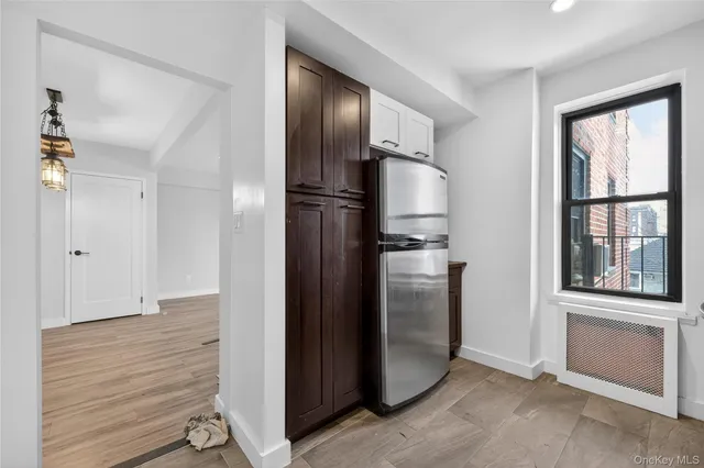 a view of a refrigerator in kitchen and wooden floor