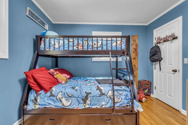 a bedroom with furniture and a flat screen tv