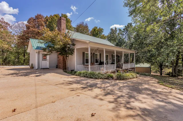 a view of a house with backyard porch and sitting area
