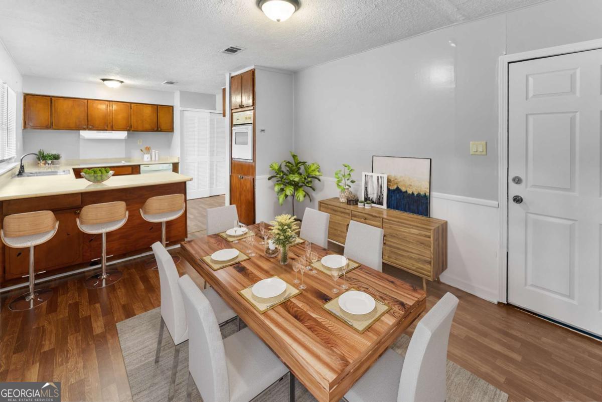 320 West Whatley Street Pooler, GA 31322 - Photo 23 of 34 a view of a dining room with furniture a rug and wooden floor