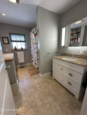 a bathroom with a sink a vanity and a mirror