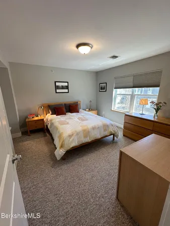 a bedroom with bed and window