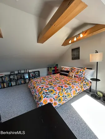 a bedroom with a bed and dresser