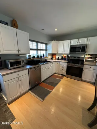 a kitchen with stainless steel appliances granite countertop a sink dishwasher stove top oven and refrigerator