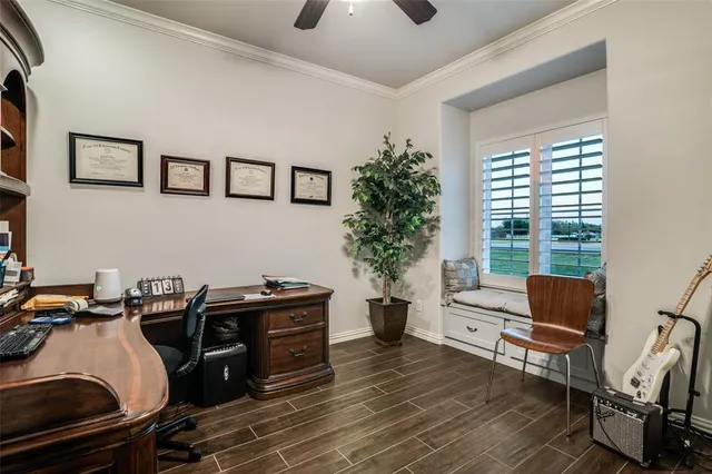 a view of a workspace with furniture and a window