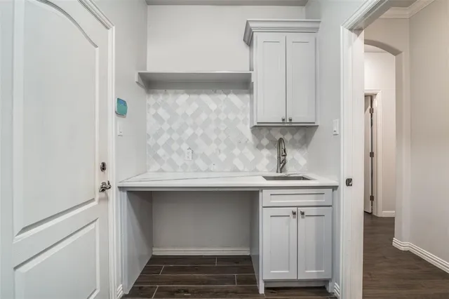 a bathroom with a sink and cabinets