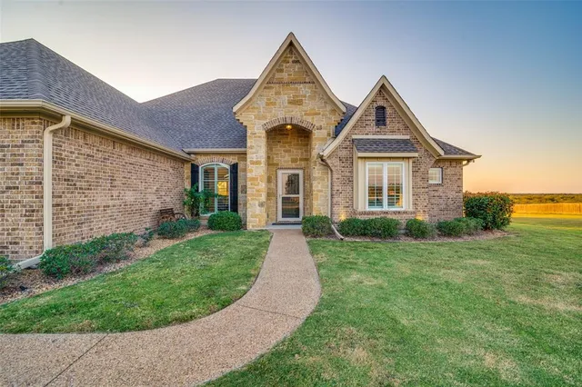 a front view of a house with garden