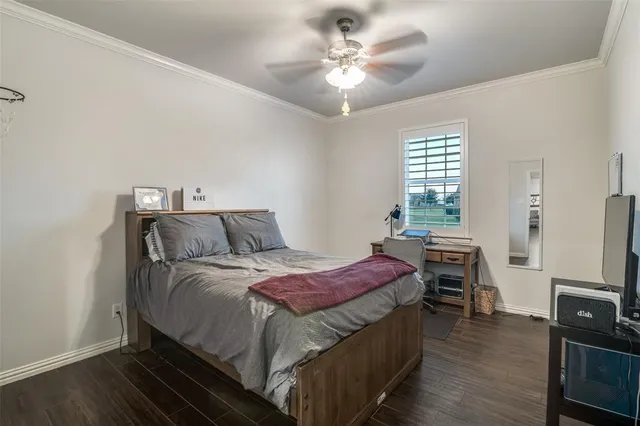 a bedroom with a bed and a tv