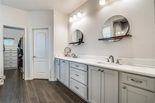 a bathroom with a double vanity sink and a mirror