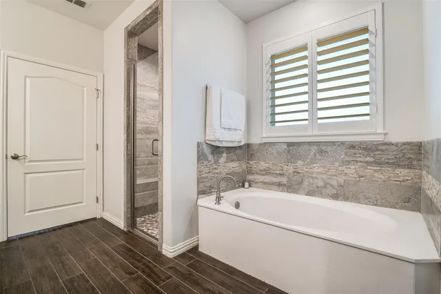 a bathroom with a bathtub and a window
