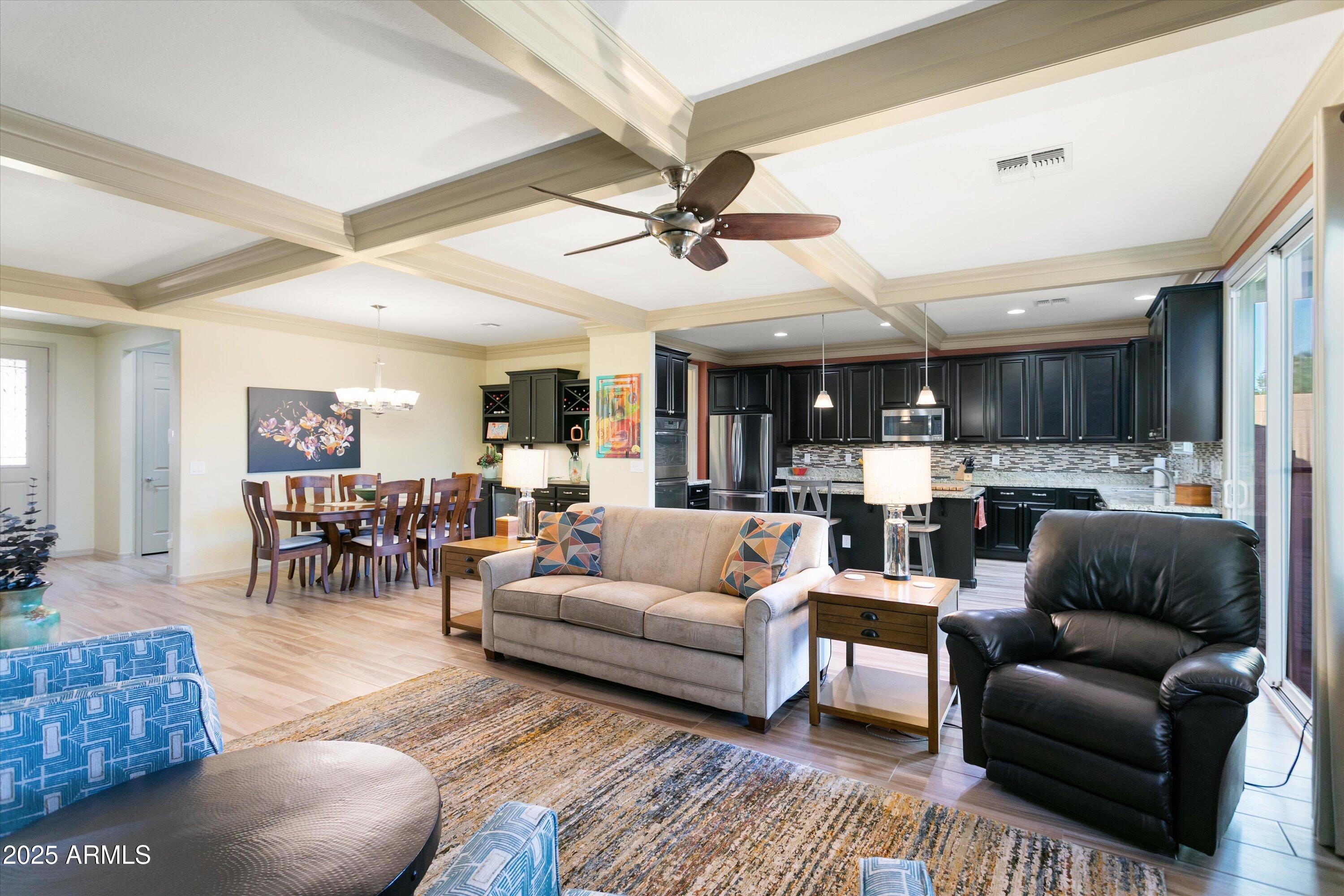 3197 North Springfield Street Buckeye, AZ 85396 - Photo 12 of 60 a living room with furniture kitchen view and a chandelier