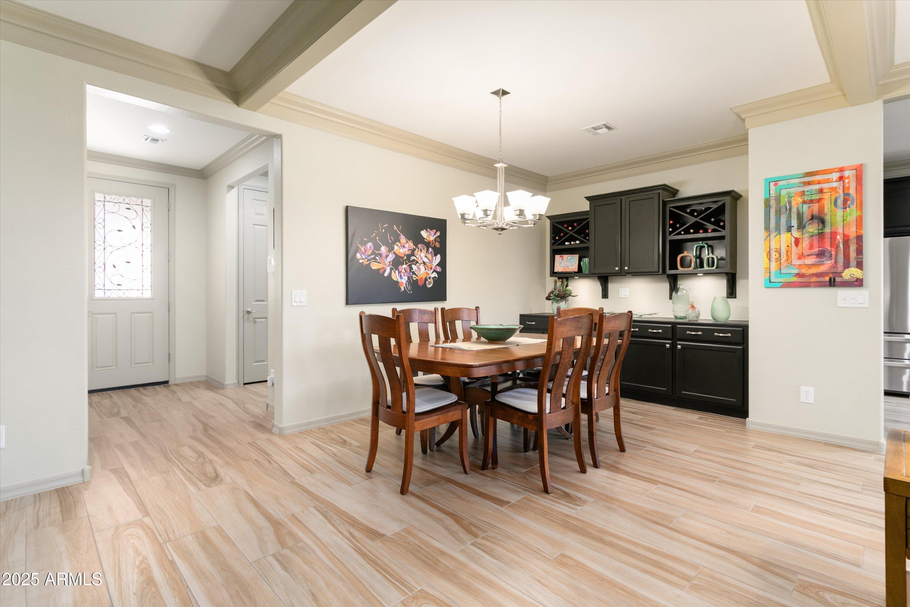 3197 North Springfield Street Buckeye, AZ 85396 - Photo 22 of 60 a view of a dining room with furniture and wooden floor