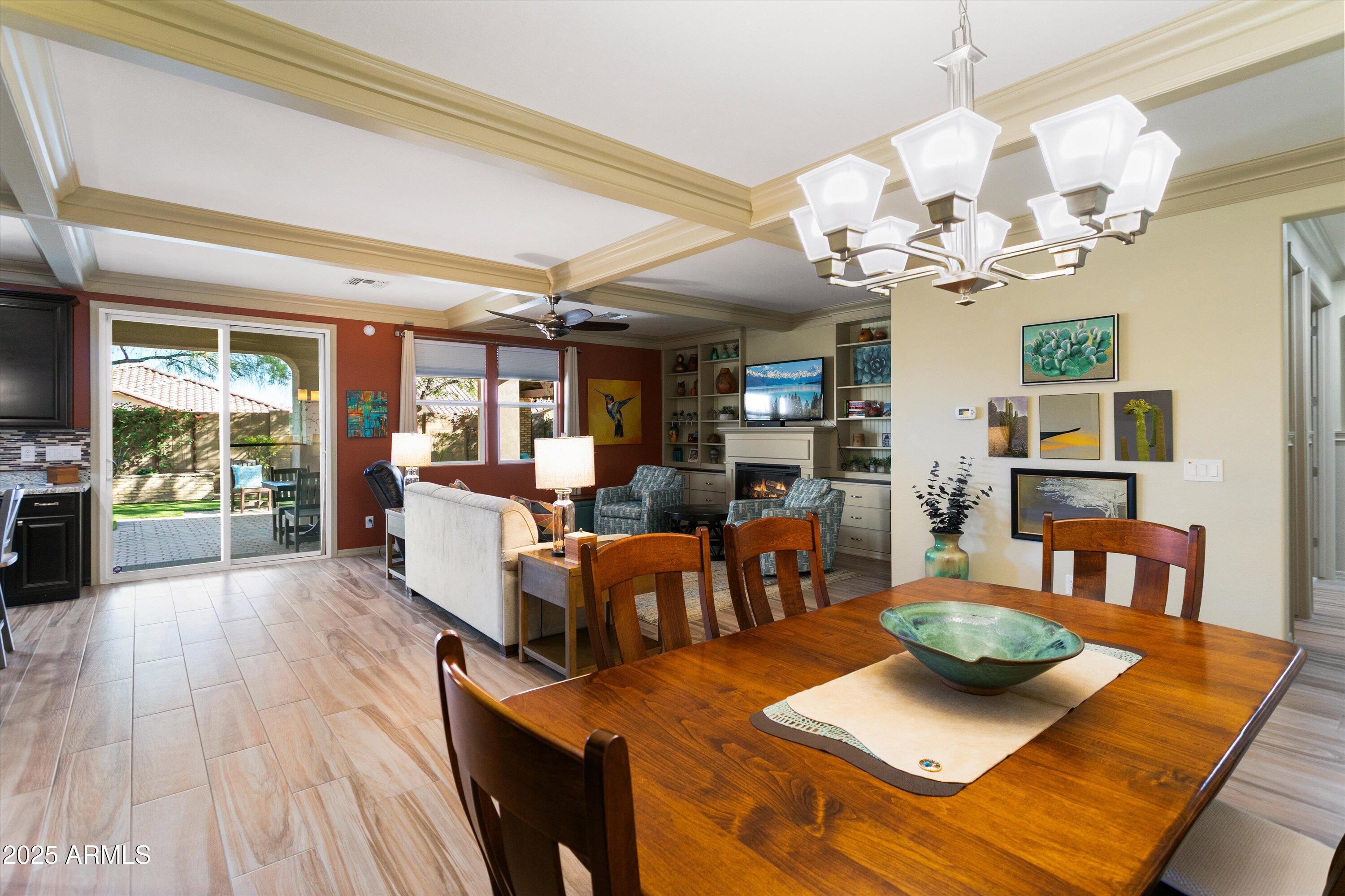3197 North Springfield Street Buckeye, AZ 85396 - Photo 23 of 60 a view of a dining room with furniture a chandelier and wooden floor