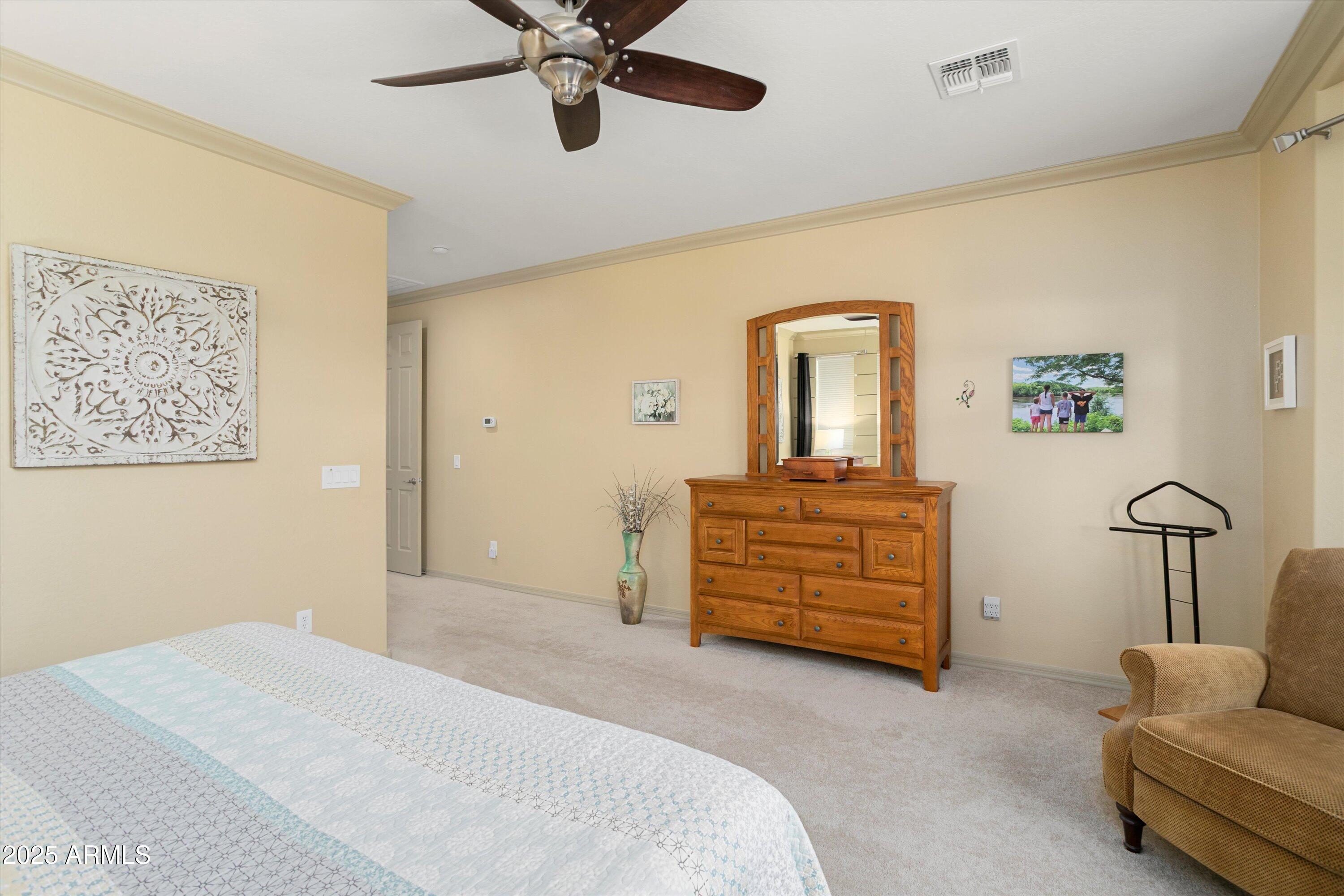 3197 North Springfield Street Buckeye, AZ 85396 - Photo 28 of 60 a bedroom with a bed and furniture