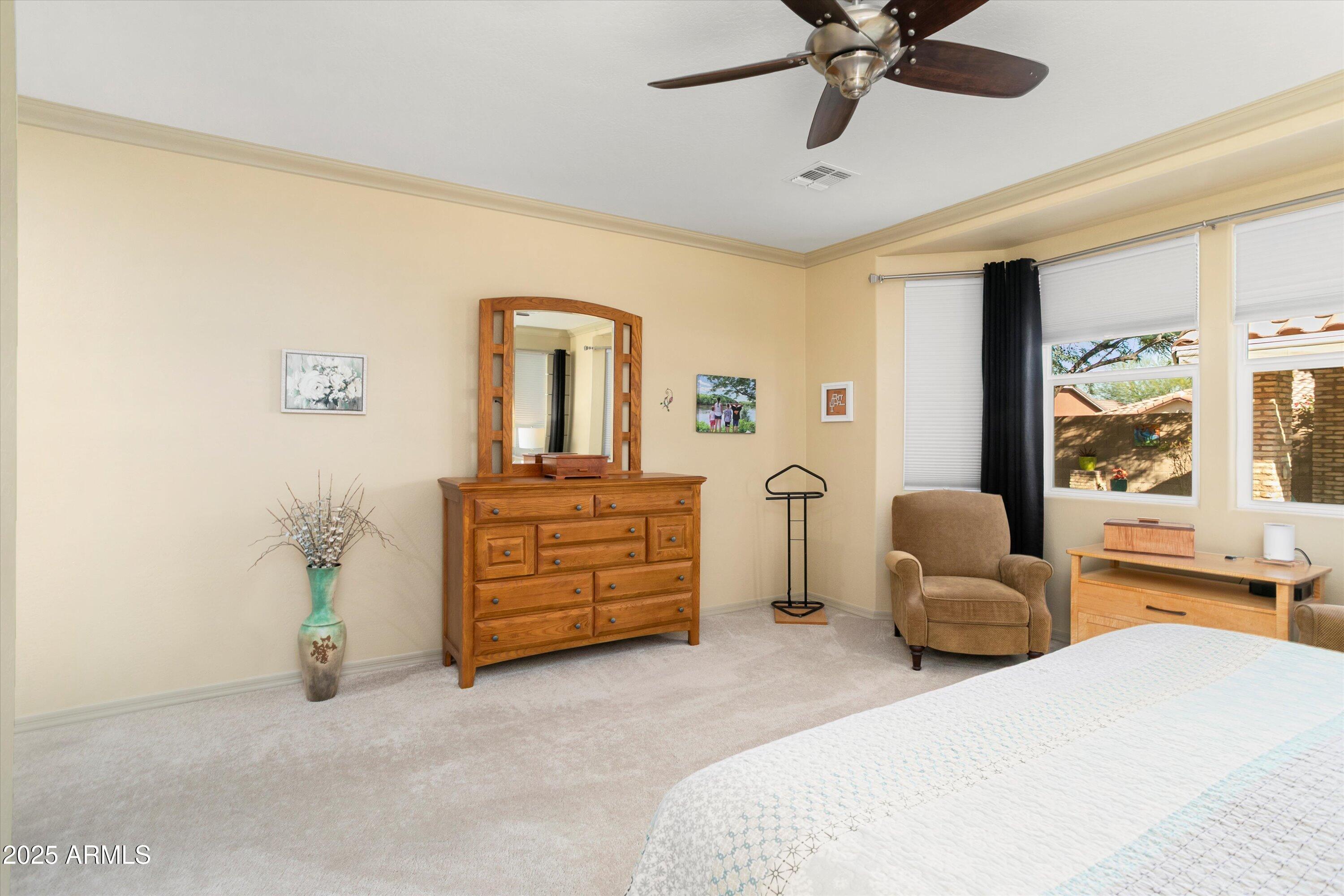 3197 North Springfield Street Buckeye, AZ 85396 - Photo 29 of 60 a bedroom with a bed and ceiling fan