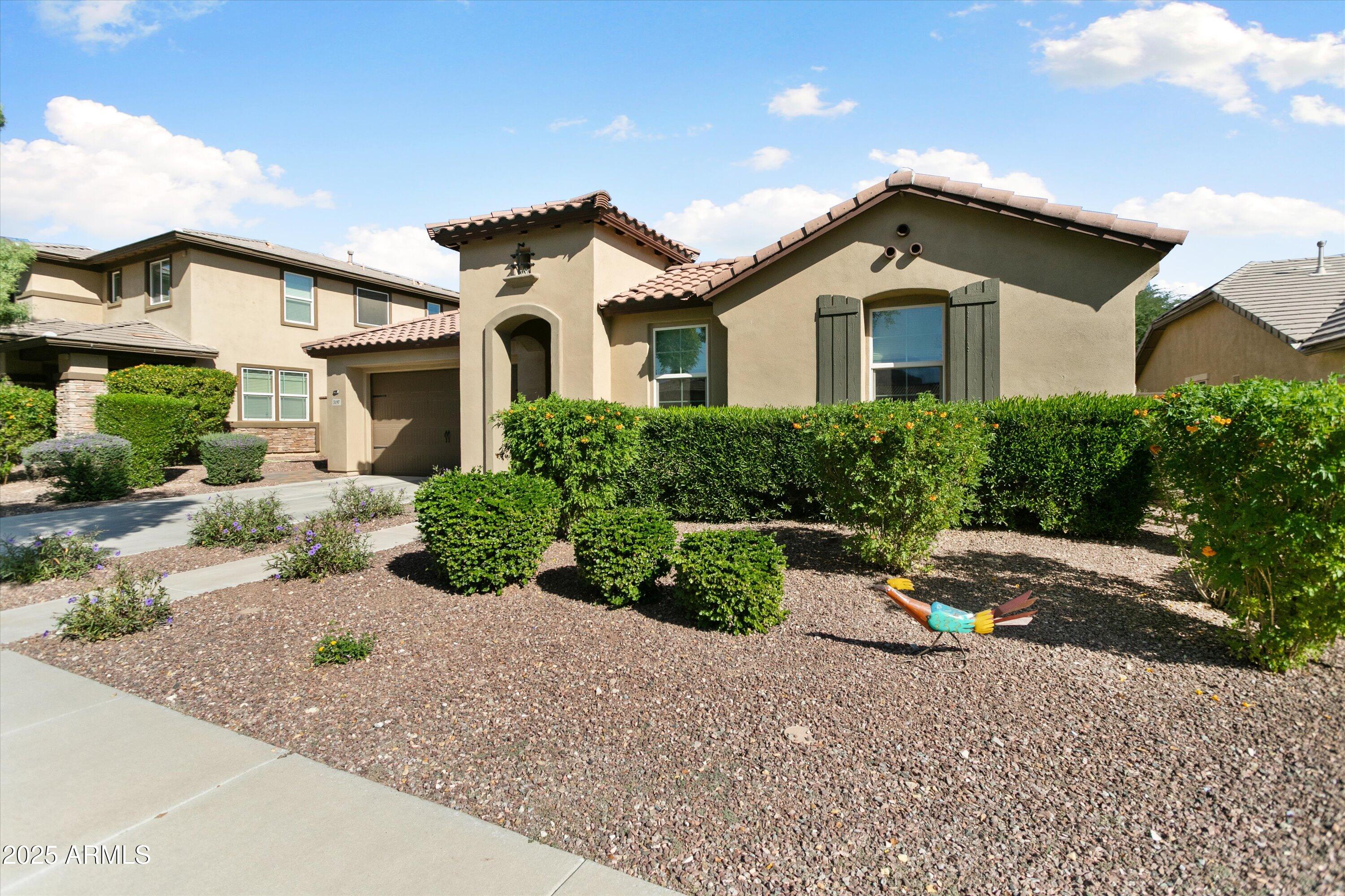 3197 North Springfield Street Buckeye, AZ 85396 - Photo 2 of 60 a front view of a house with a yard