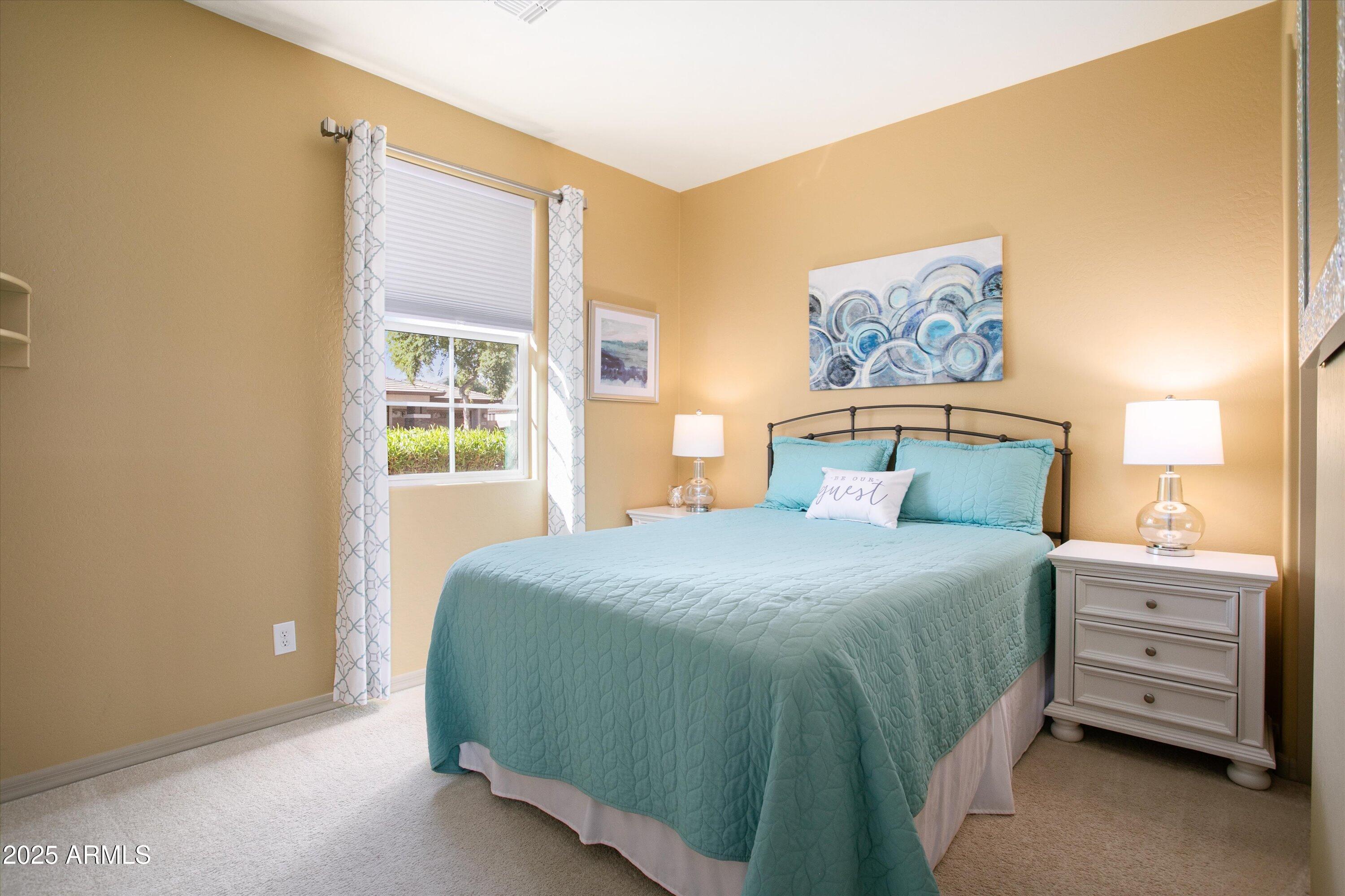 3197 North Springfield Street Buckeye, AZ 85396 - Photo 32 of 60 a bedroom with a bed and a window