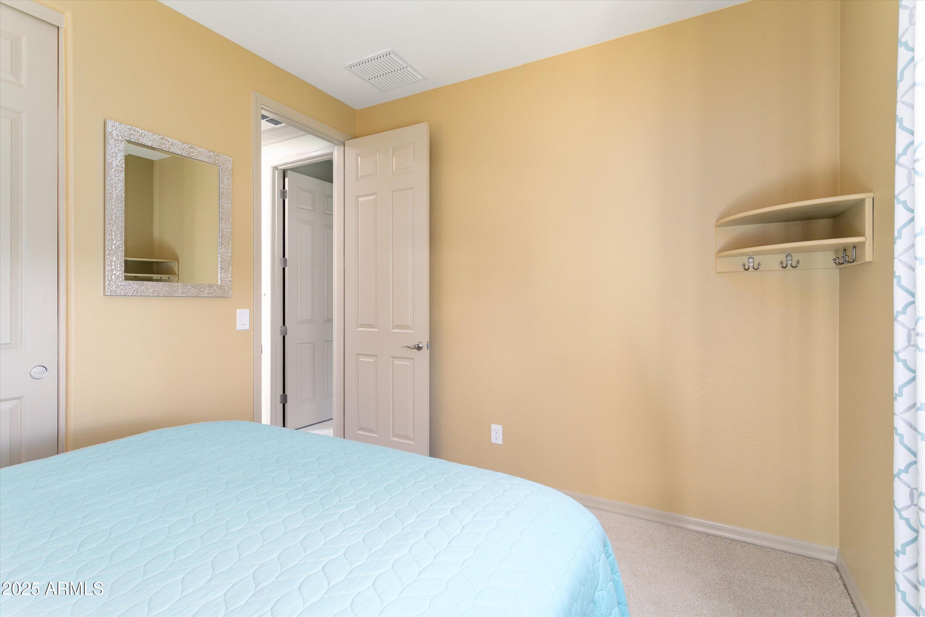 3197 North Springfield Street Buckeye, AZ 85396 - Photo 33 of 60 a bedroom with a bed and a mirror