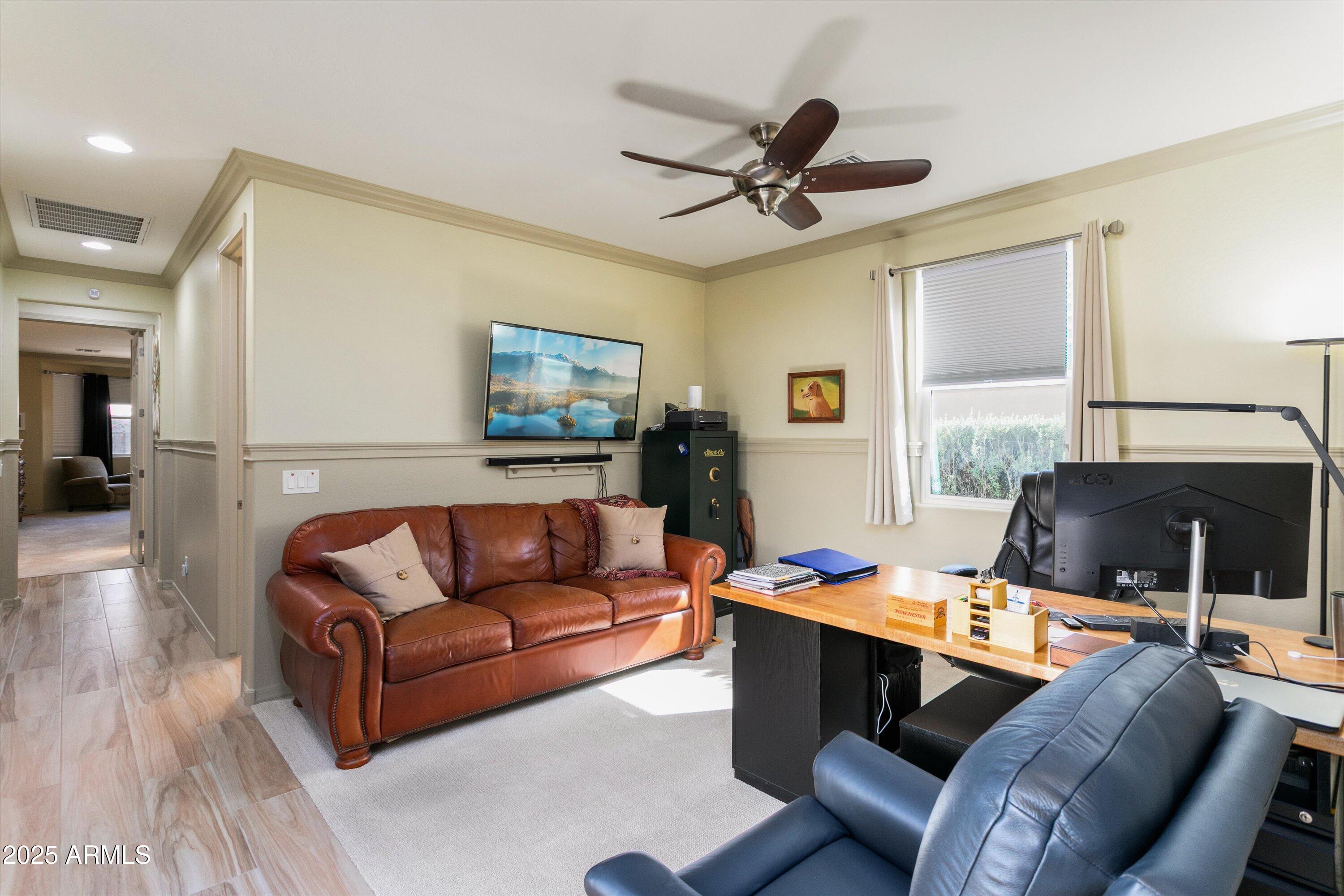 3197 North Springfield Street Buckeye, AZ 85396 - Photo 40 of 60 a living room with furniture and a flat screen tv