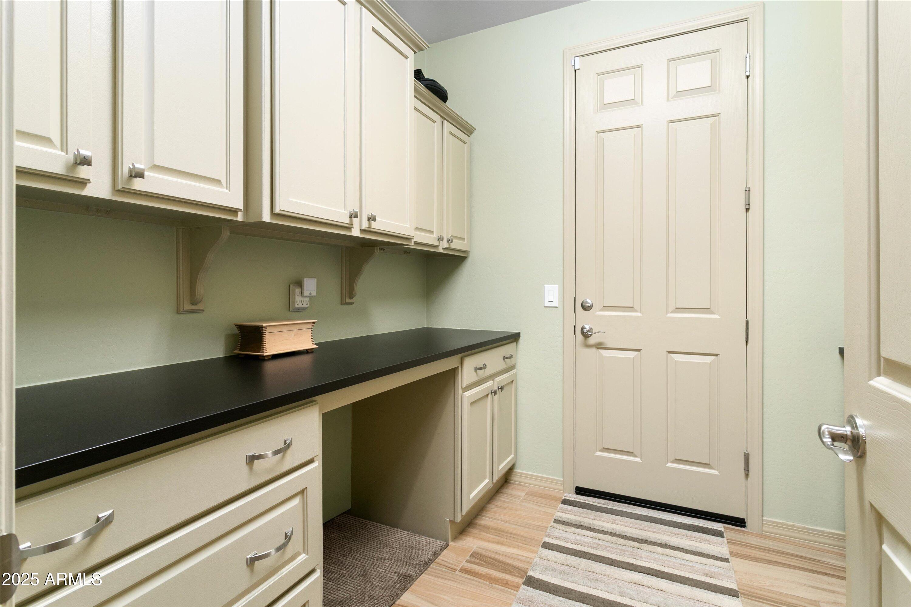 3197 North Springfield Street Buckeye, AZ 85396 - Photo 43 of 60 a kitchen with granite countertop white cabinets and black appliances