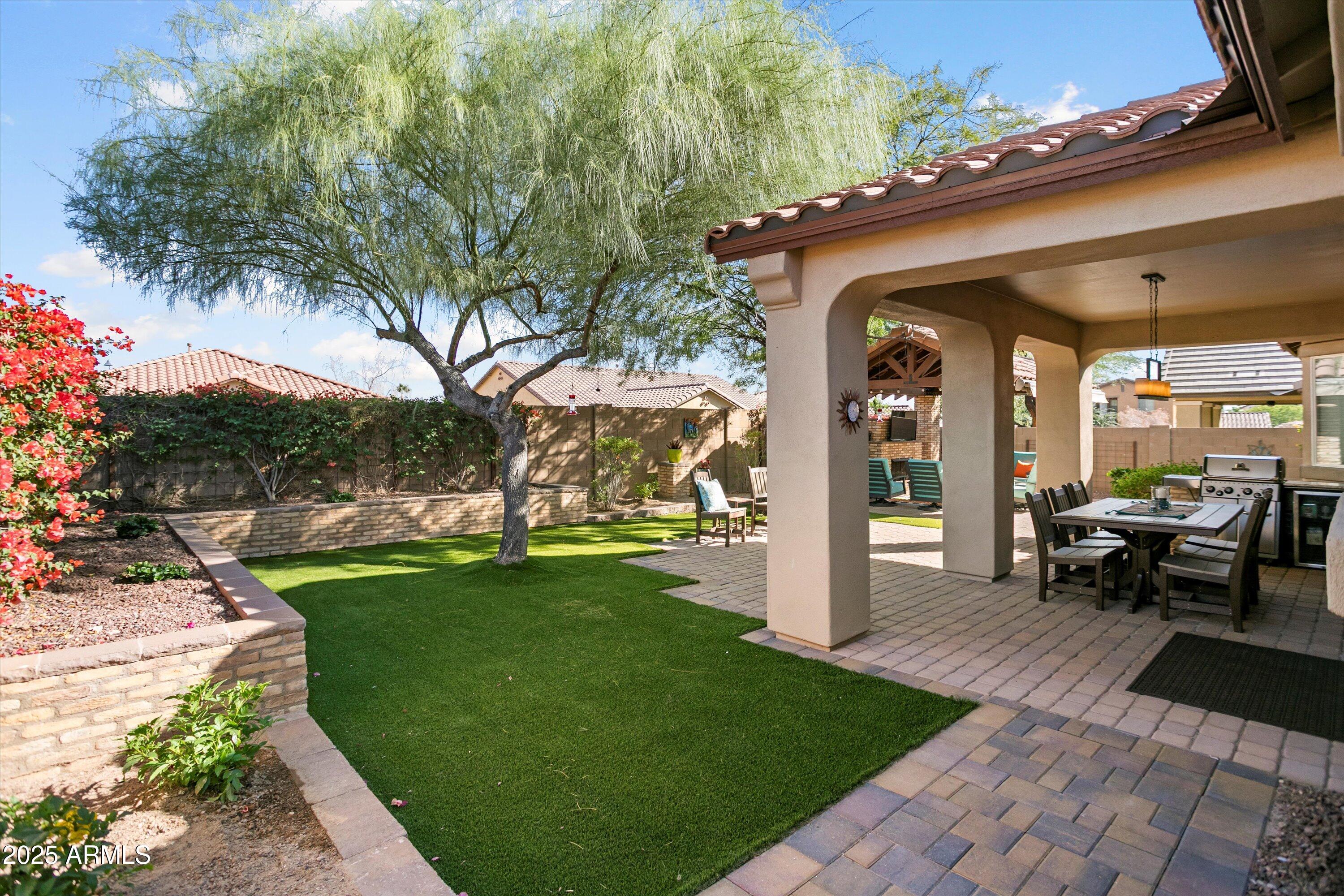 3197 North Springfield Street Buckeye, AZ 85396 - Photo 47 of 60 a view of a house with backyard porch and garden