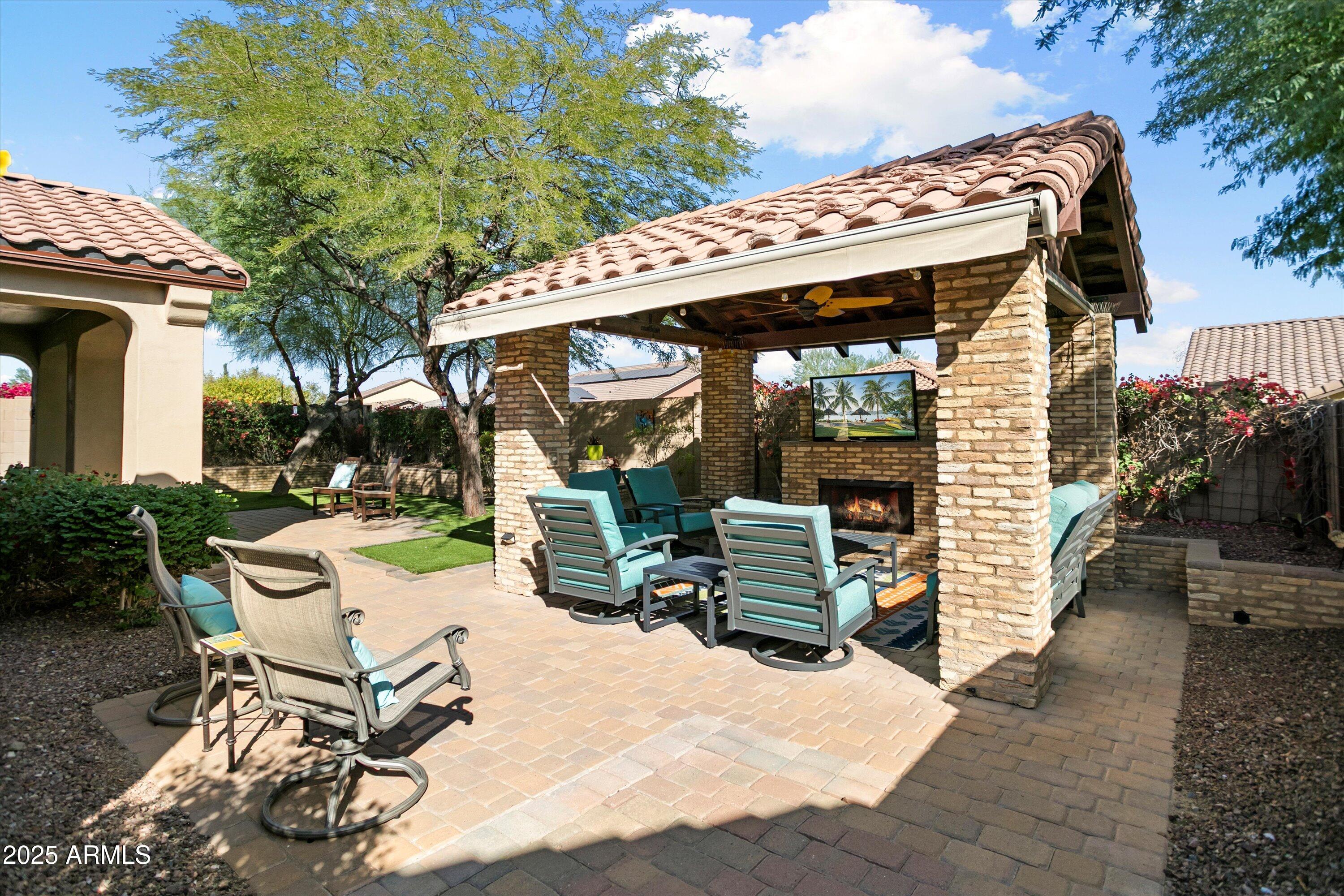 3197 North Springfield Street Buckeye, AZ 85396 - Photo 49 of 60 a view of a chairs and table in backyard of the house