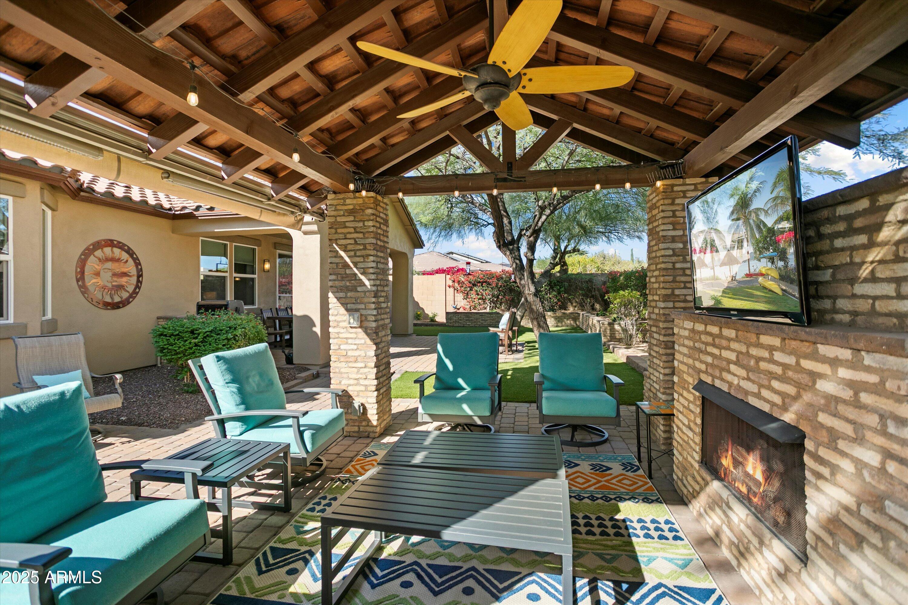 3197 North Springfield Street Buckeye, AZ 85396 - Photo 52 of 60 a living room with fireplace furniture and a flat screen tv