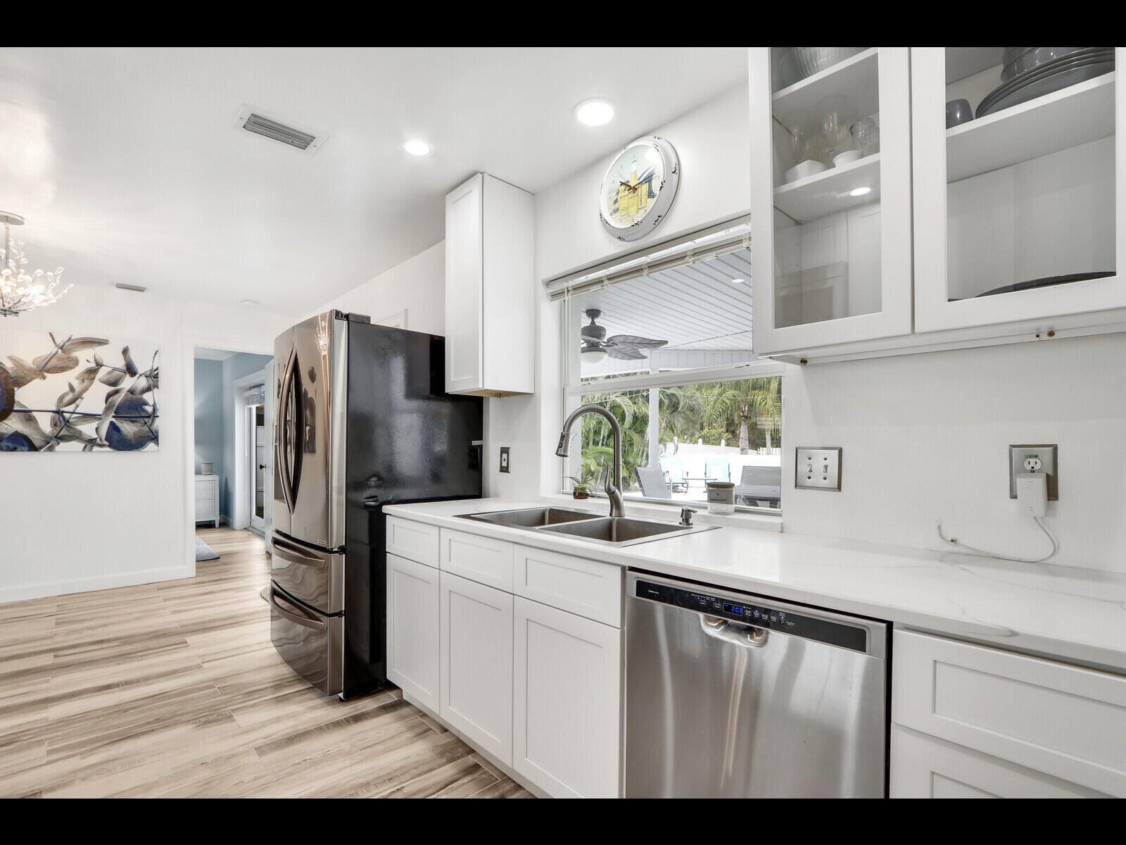 609 Oak Terrace Jupiter, FL 33458 - Photo 10 of 28 a kitchen with a sink stainless steel appliances and cabinets