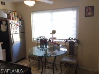 103 Oregon Road West Lehigh Acres, FL 33936 - Photo 8 of 22 a view of a dining room with furniture and window