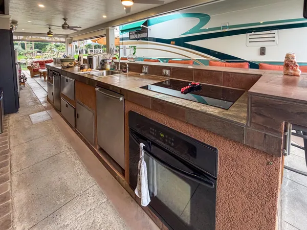 a kitchen with stainless steel appliances granite countertop a sink and a stove