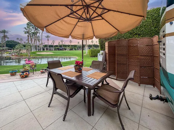 a view of an outdoor sitting area with furniture and backyard